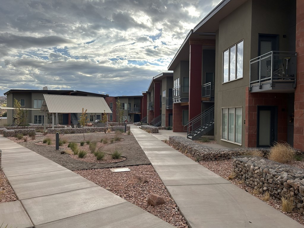 A row of modern houses with a walkway in between.