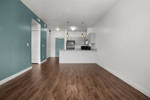 A room with a kitchenette and a dining area.