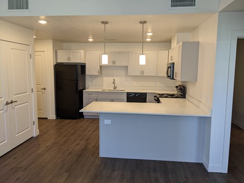 a kitchen with white cabinets and a white counter top