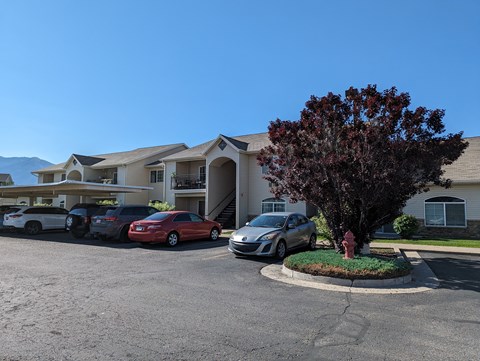 a large apartment building with cars parked in front of it