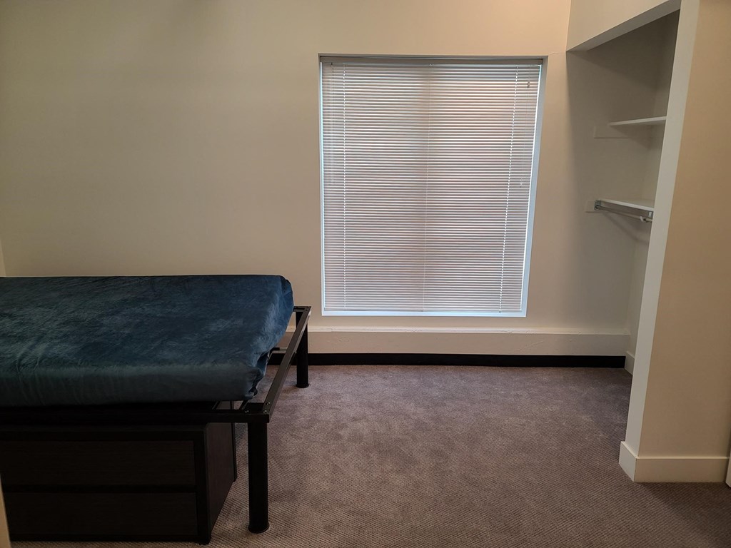 a patient room with a bench and a window