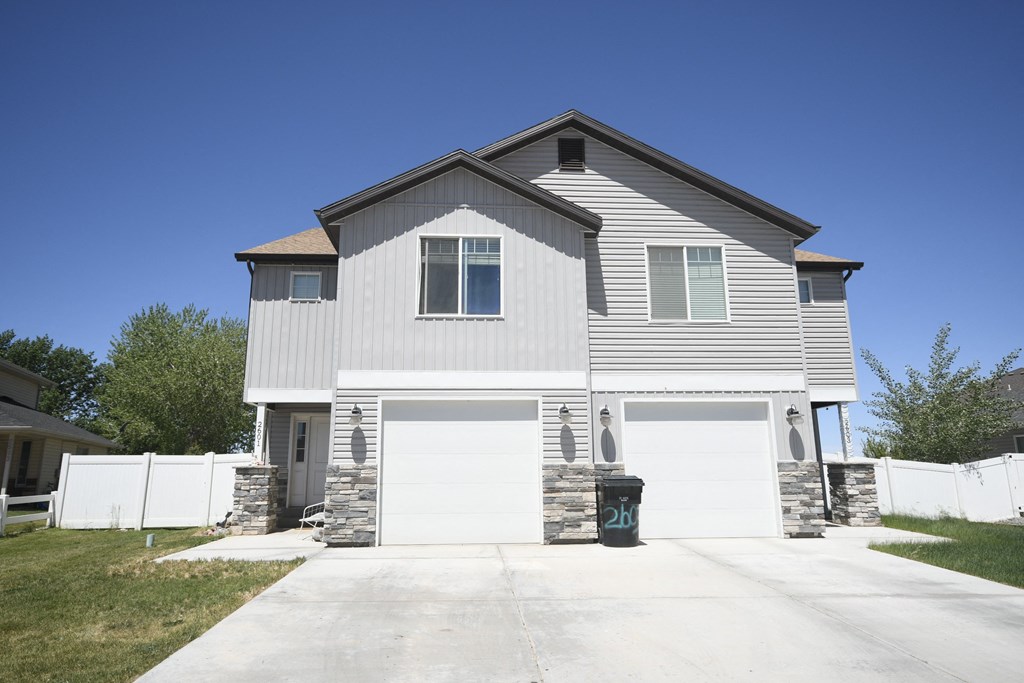 a white house with a white garage door