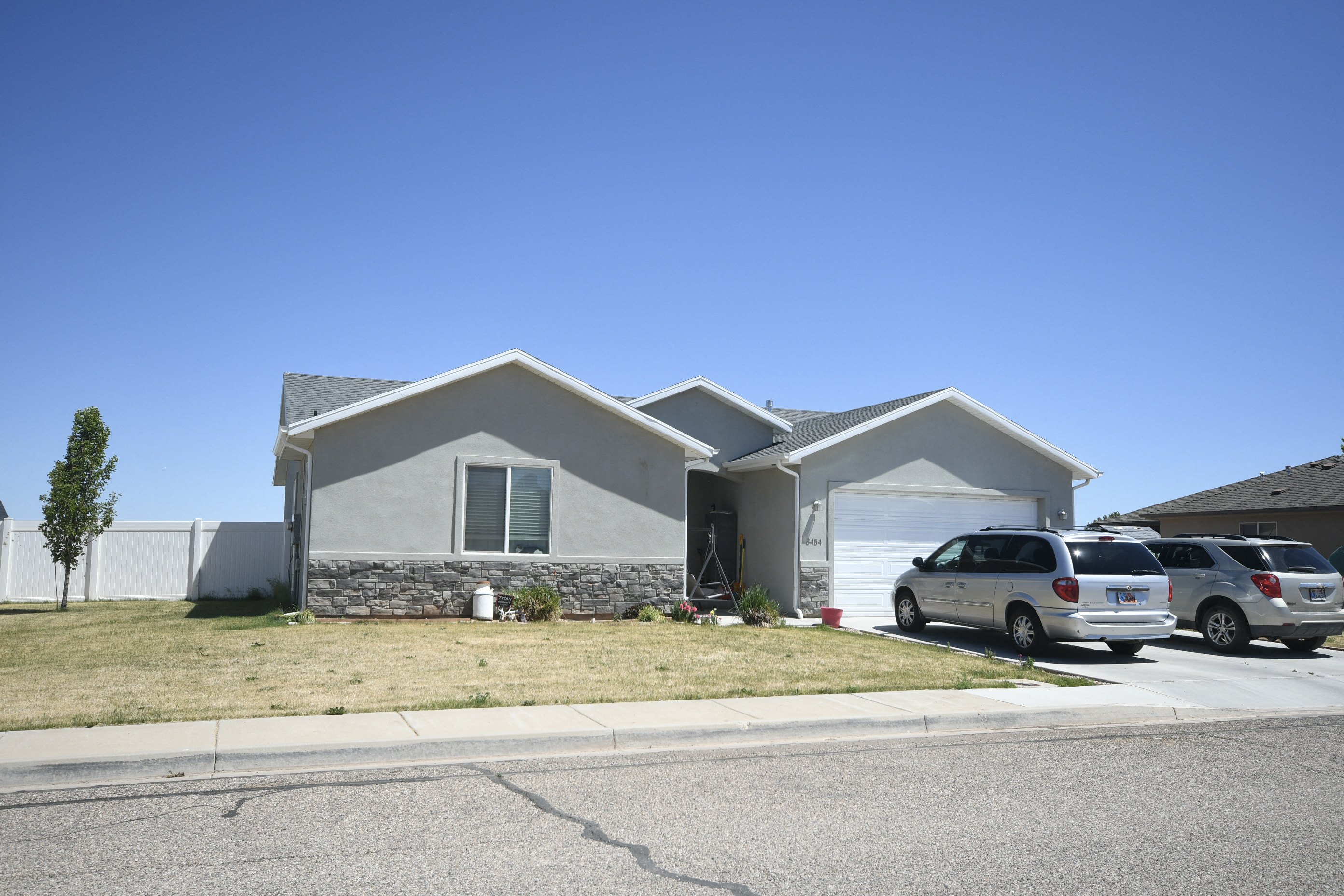 a house with two cars parked in front of it