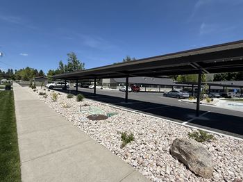 A parking lot with a large rock in the foreground.