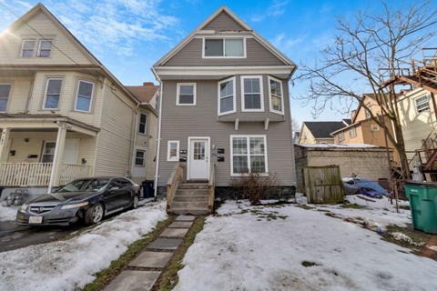A house with a car parked in front of it.