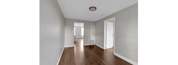 A room with wooden floors and white walls.