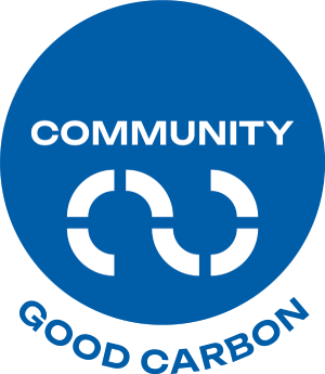A blue circle with the words "COMMUNITY" and "GOOD CARBON" written in white.