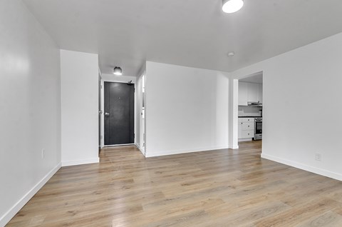 A room with wooden floors and white walls.