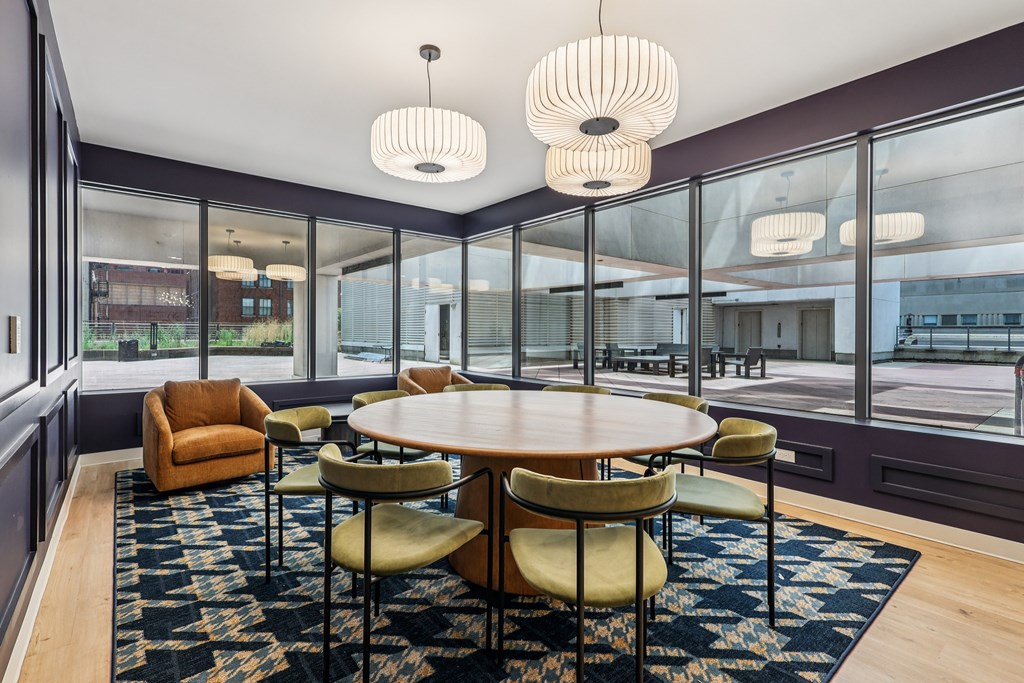 A modern dining room with a round table and chairs.