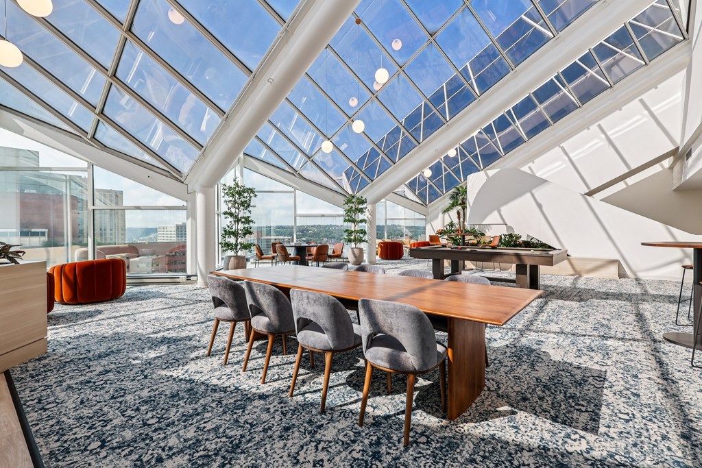 A conference room with a long table and chairs.