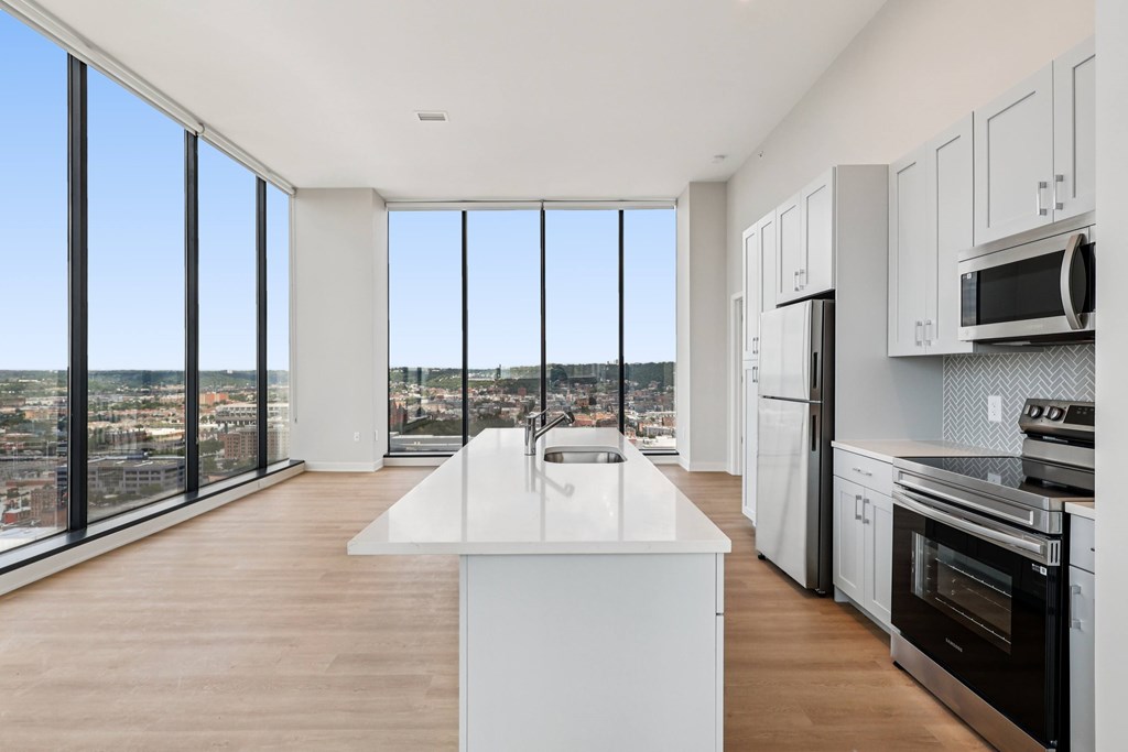 A modern kitchen with a view of the city.