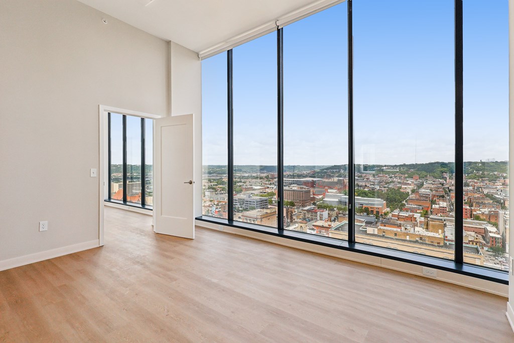 A large empty room with a view of the city.