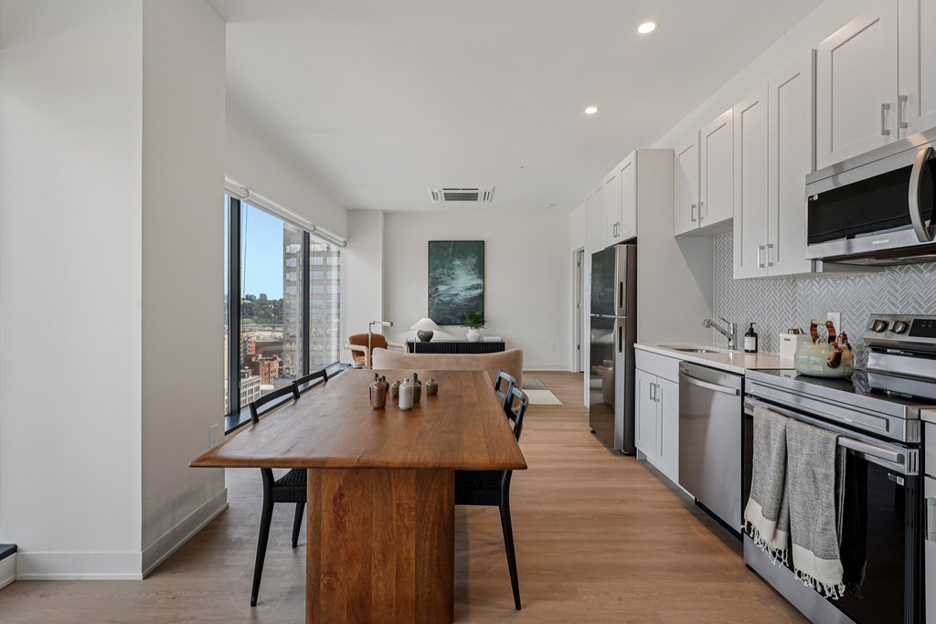 A modern kitchen with a wooden island and stainless steel appliances.