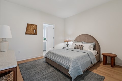 A bedroom with a large bed and a small table at 7 West 7th Apartments, Cincinnati, OH