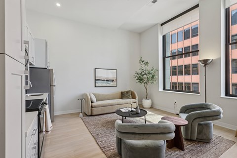 A modern living room with a grey sofa and a coffee table.