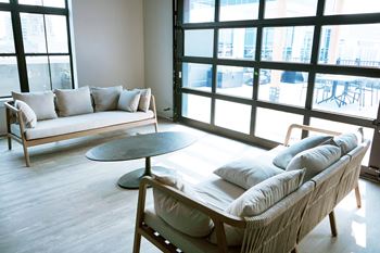 A living room with a couch, chair, and table. at The Pearl, Indiana