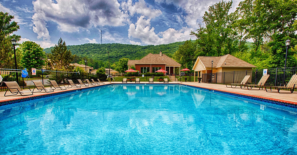 a large swimming pool in front of a house