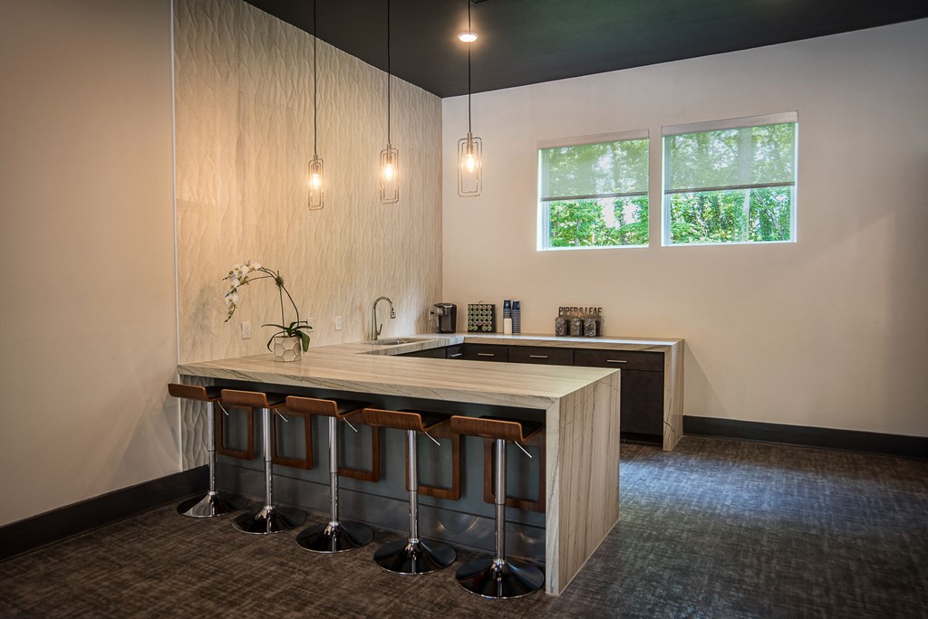 a kitchen with a counter top and bar stools