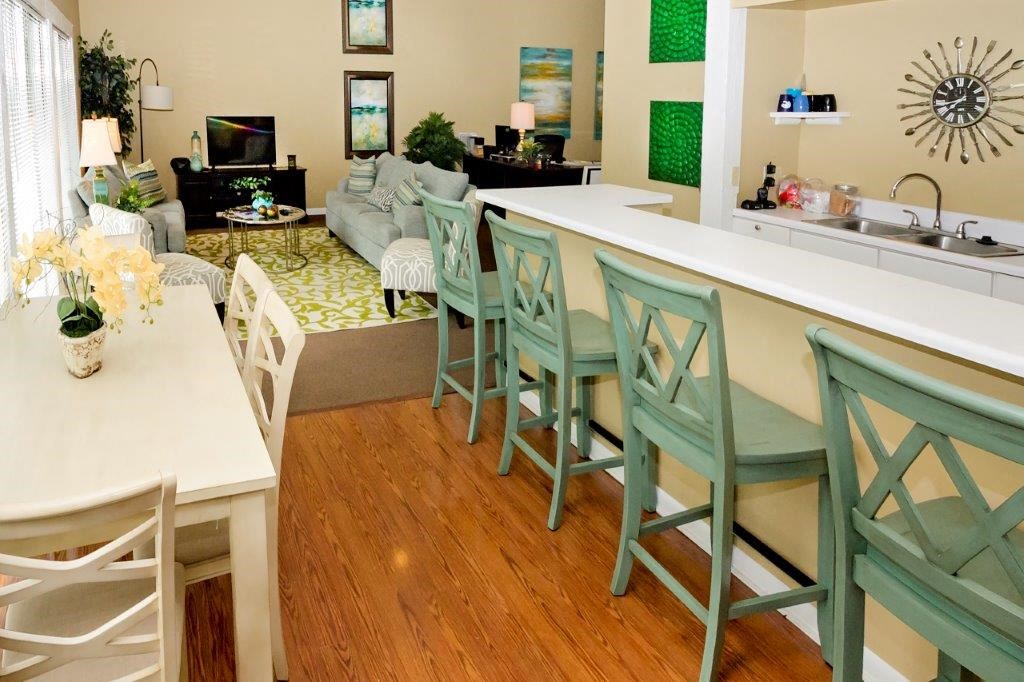 a dining room and living room with a table and chairs