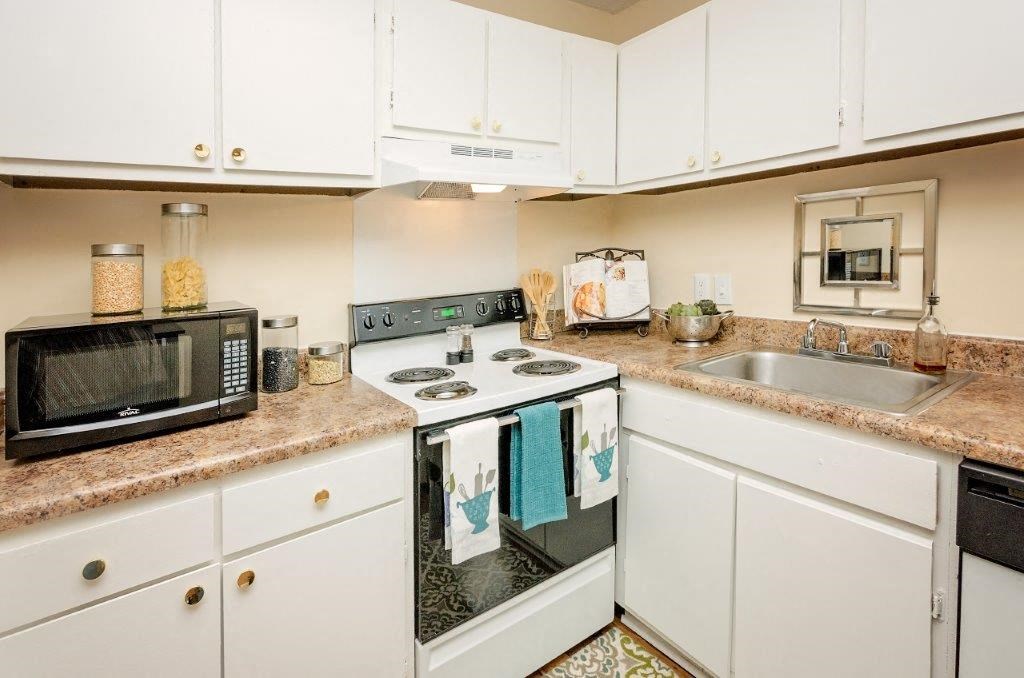 a kitchen with a stove microwave oven and sink
