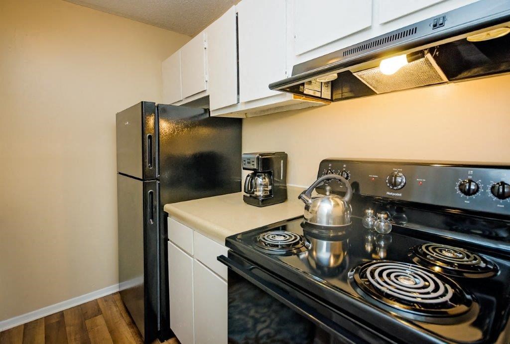 a kitchen with a stove and a refrigerator