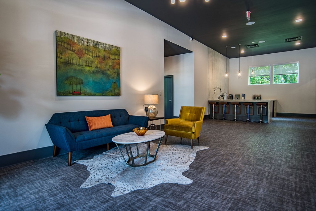 a living room with a blue couch and two yellow chairs