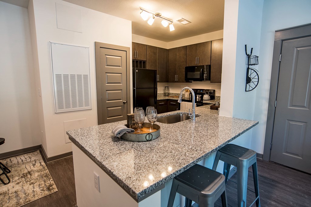 a kitchen with a granite counter top and a sink