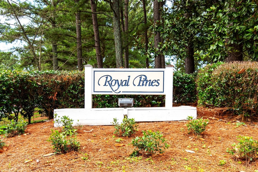 a sign that says royal lines in front of some trees