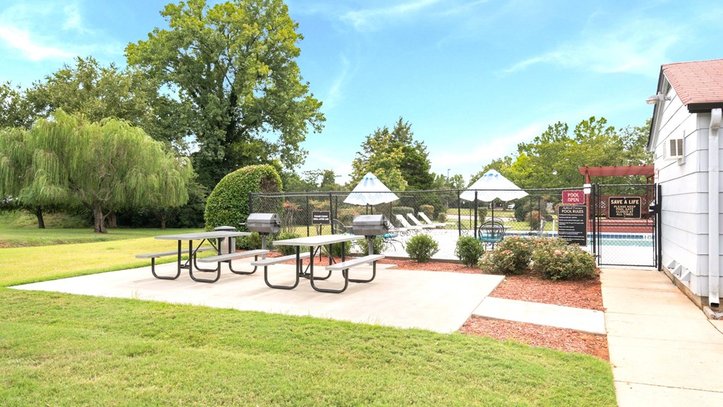 A park with a picnic table and a playground.
