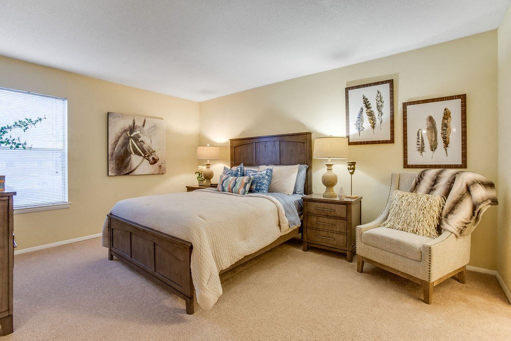 a bedroom with a bed and a chair