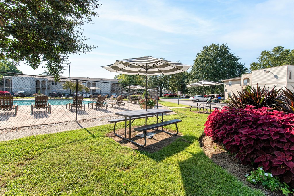 our apartments have a pool and a patio with umbrellas