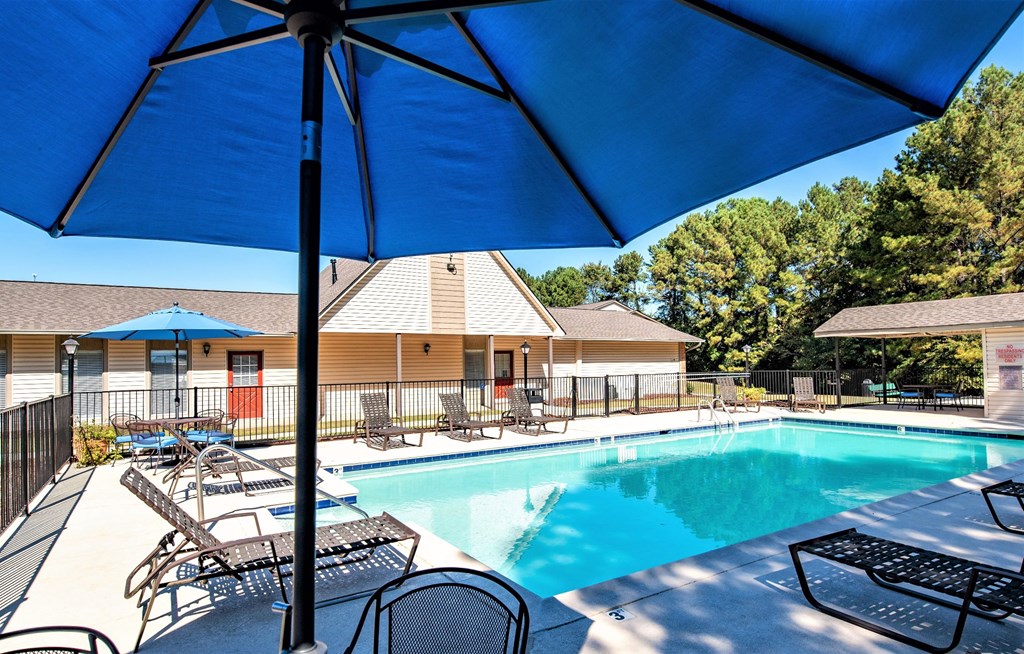 our apartments have a swimming pool with chairs and umbrellas