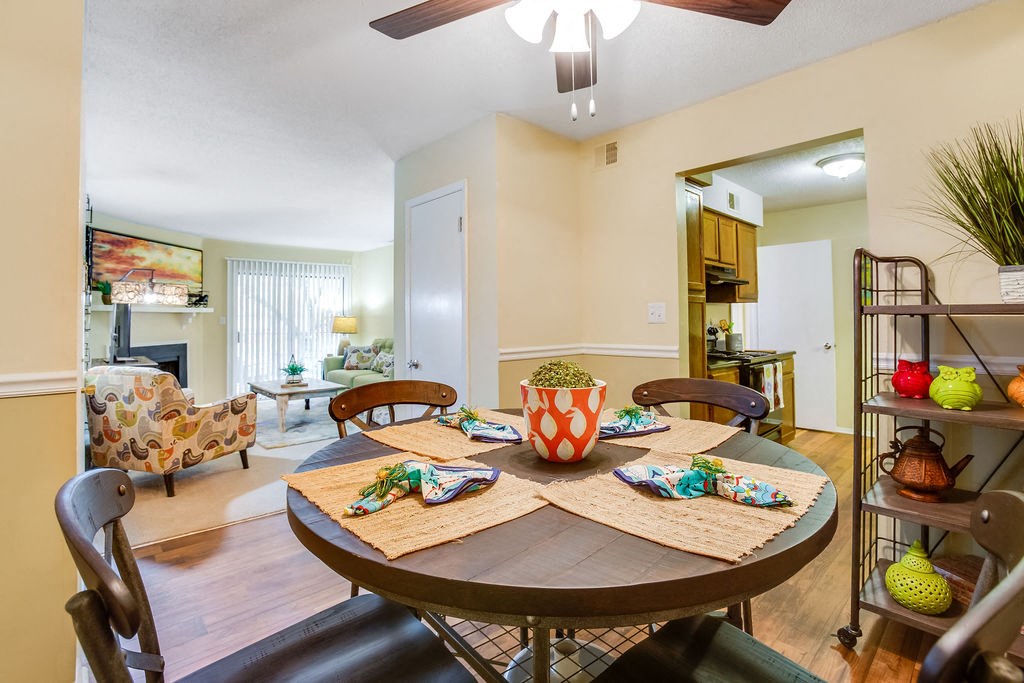 a dining room with a table and a living room