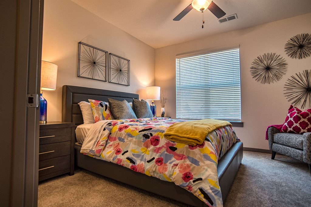 a bedroom with a bed and a ceiling fan