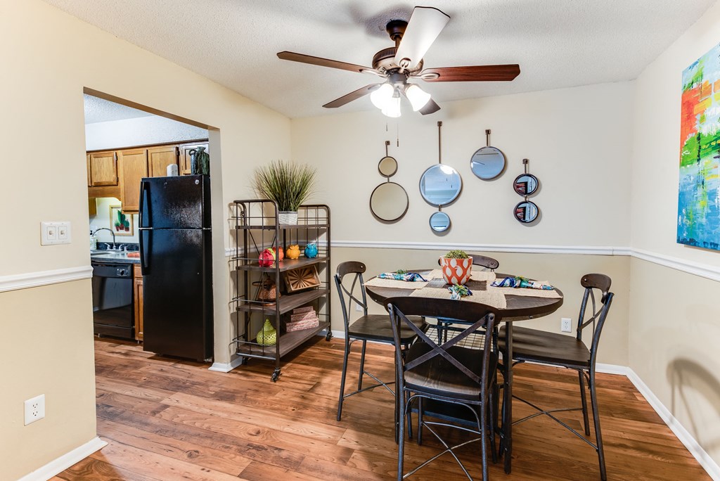 a dining room with a table and chairs and a ceiling fan