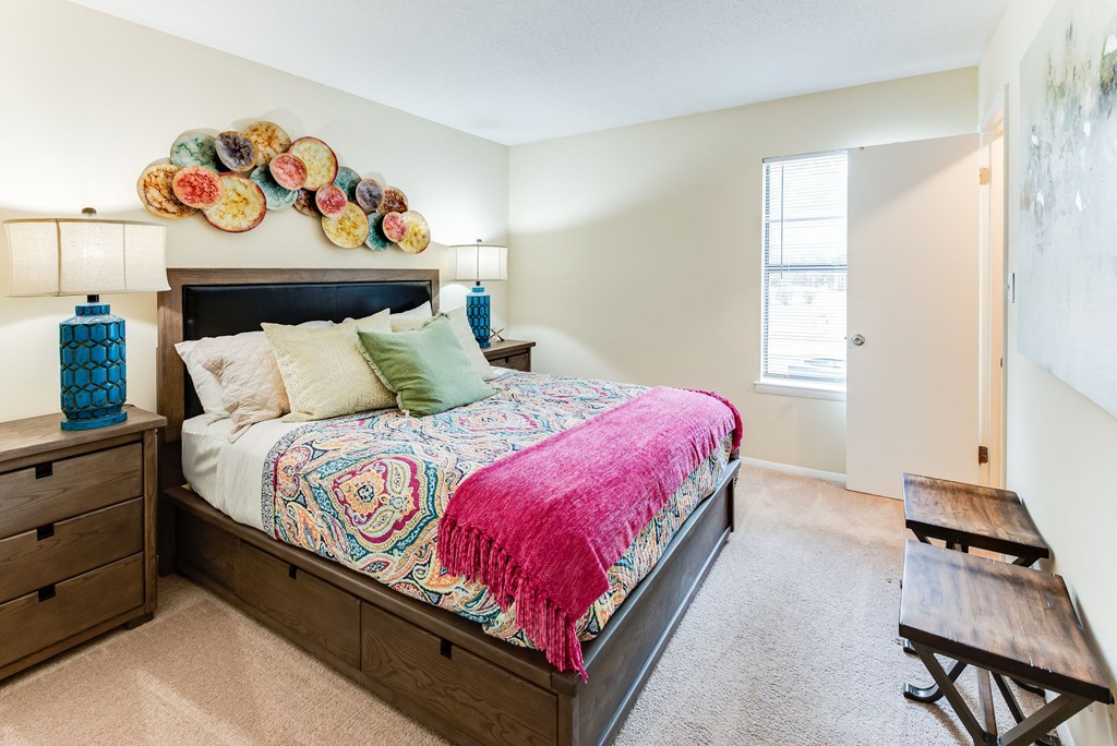 a bedroom with a bed and two night stands