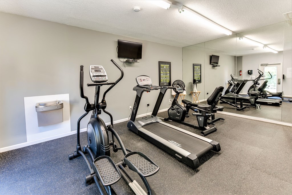 the gym with treadmills and other exercise equipment at our apartments
