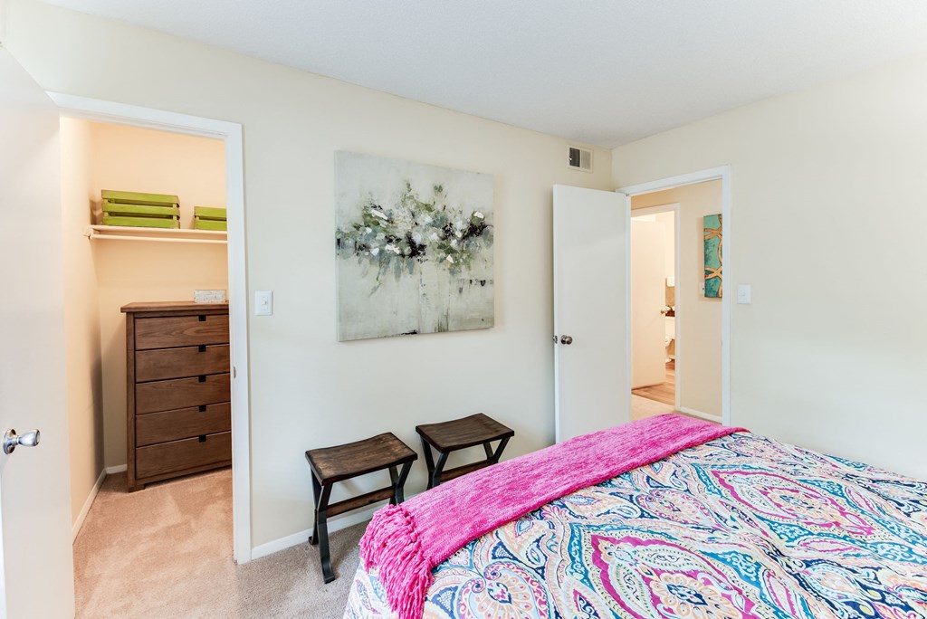 a bedroom with a large bed and two chairs