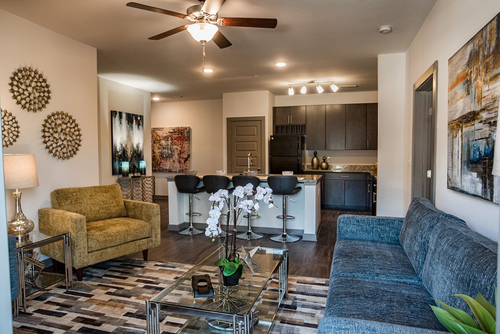 a living room with couches and a glass table