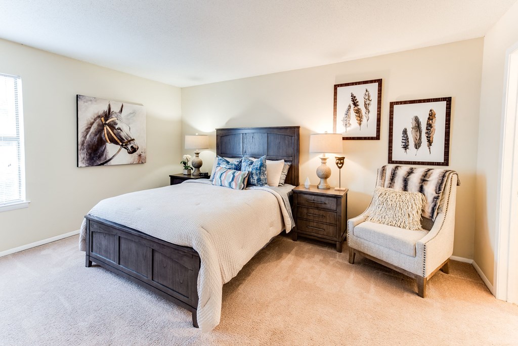 a bedroom with a bed and a chair