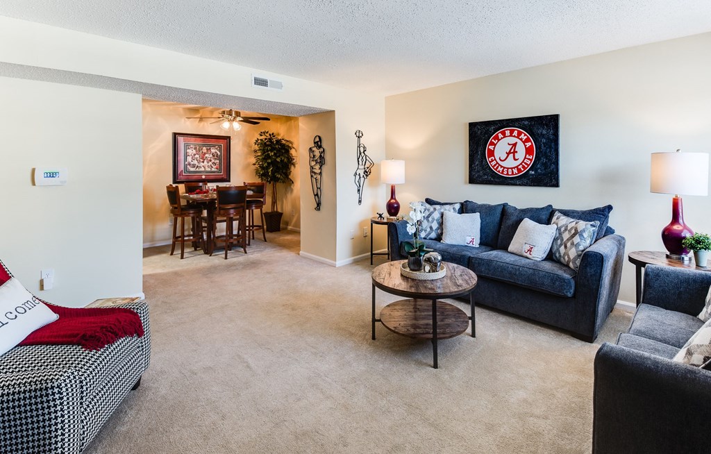 the living room and dining room of an apartment with a couch and a coffee table