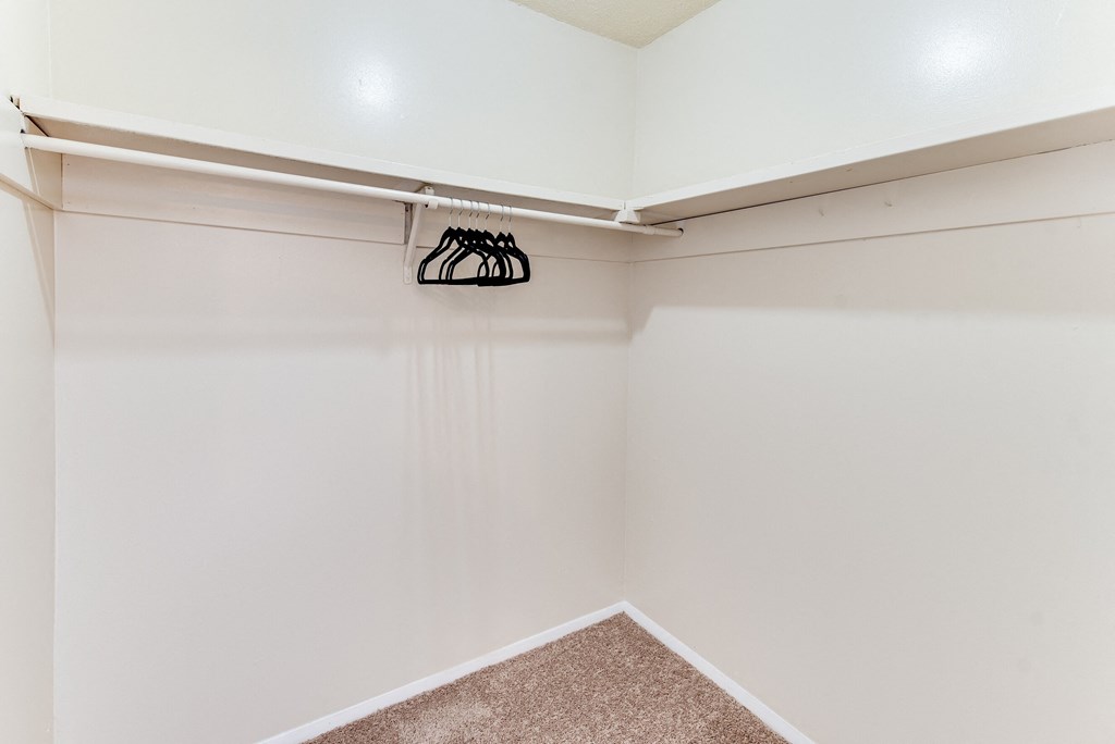 an empty closet with a shoe rack on the wall