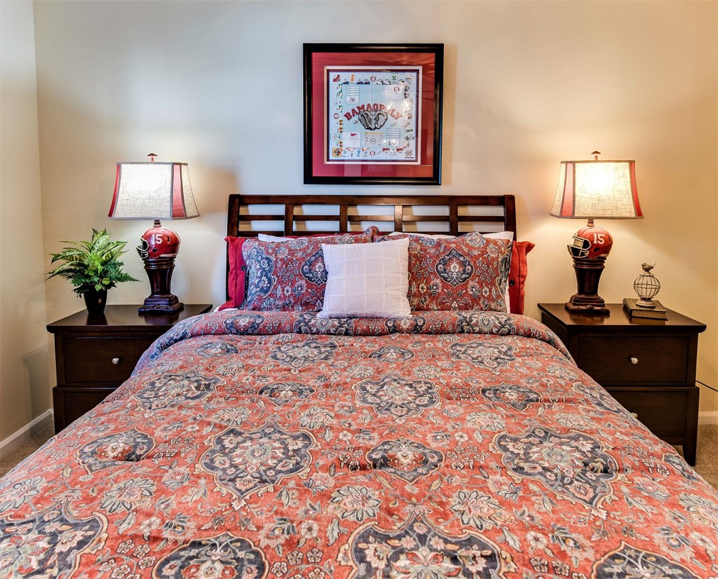 a bedroom with a bed and two lamps