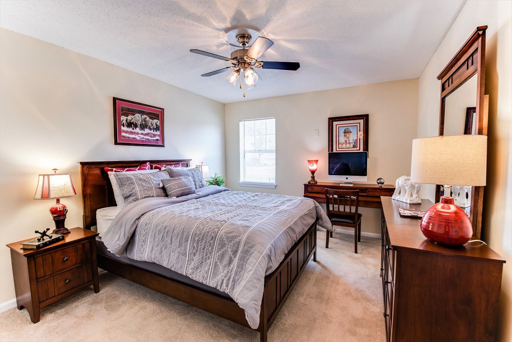 a bedroom with a bed and a ceiling fan