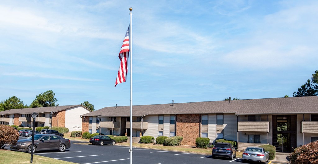a flagpole with an flag in front of a building