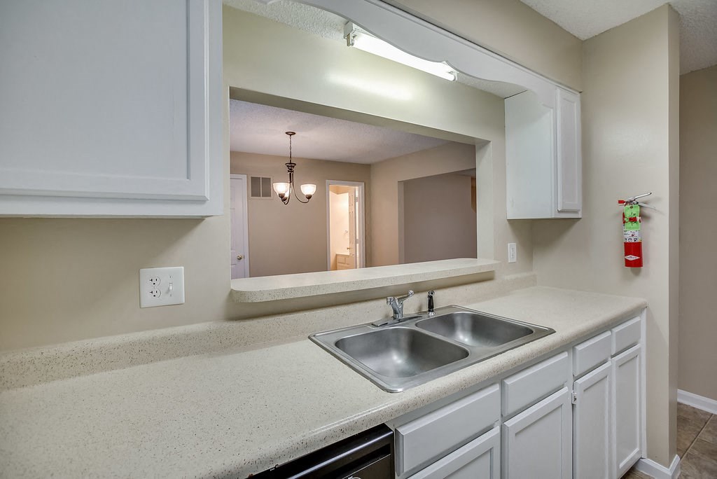 a kitchen with a sink and a mirror