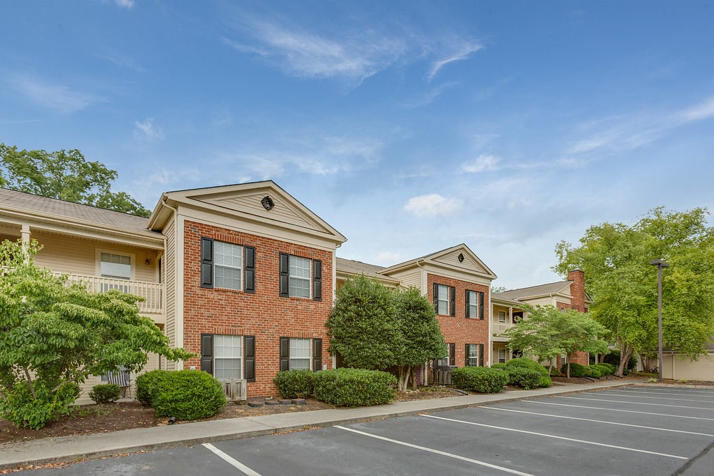 an empty parking lot in front of an apartment building