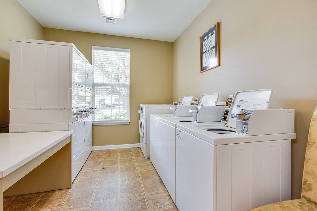 a washer and dryer in a laundry room with a window