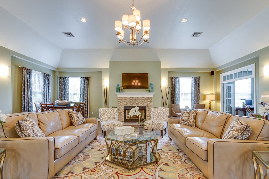 a living room with couches and chairs and a fireplace