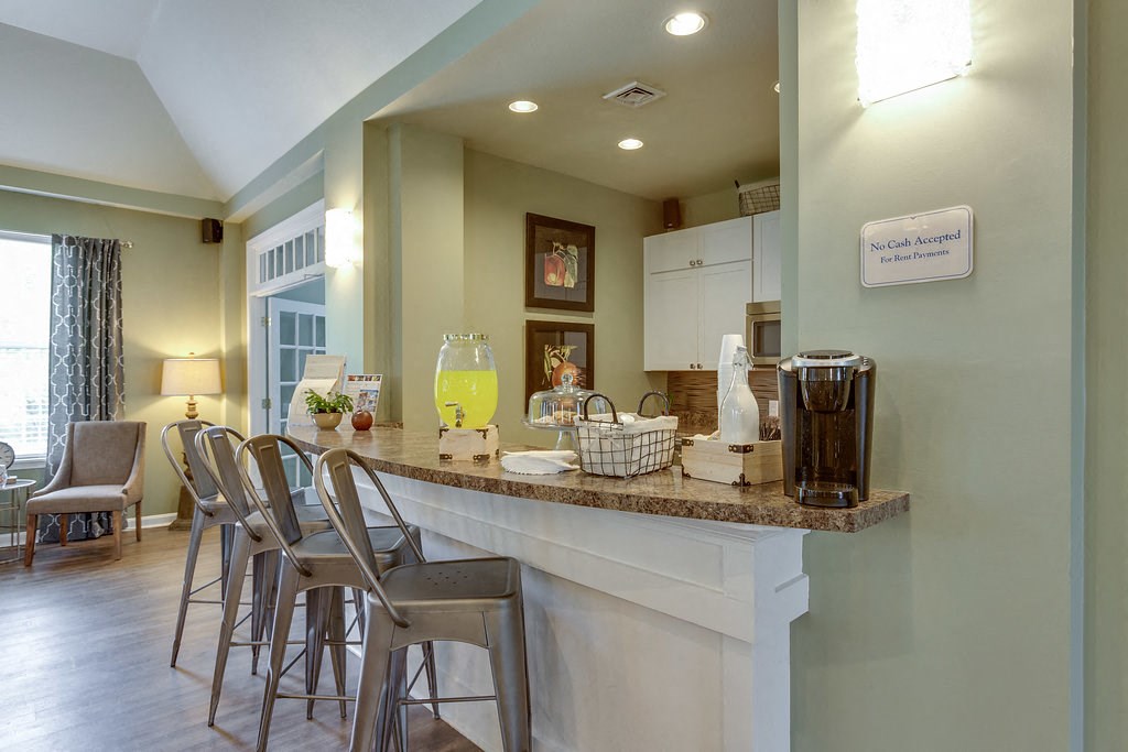 a kitchen with a counter top and bar stools